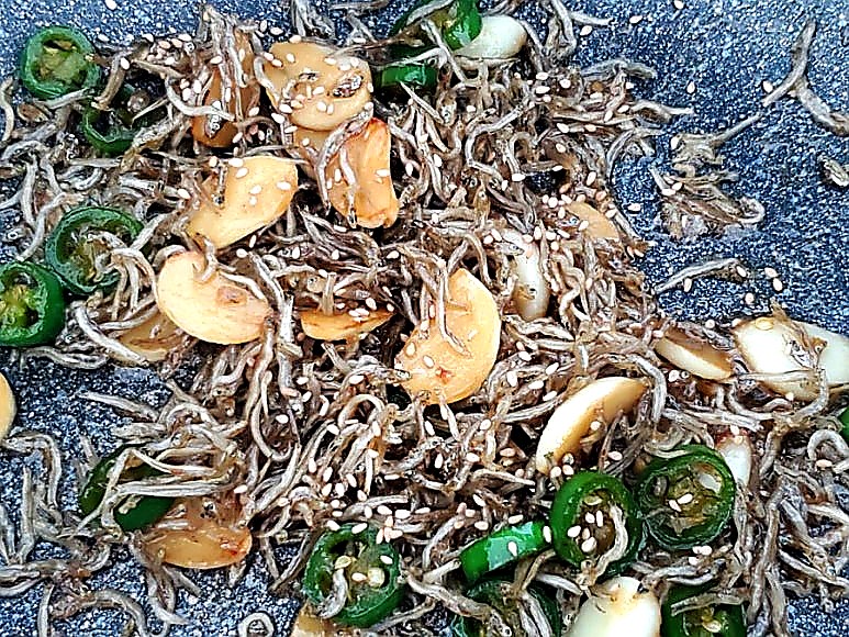 Adding a shower of sesame seeds