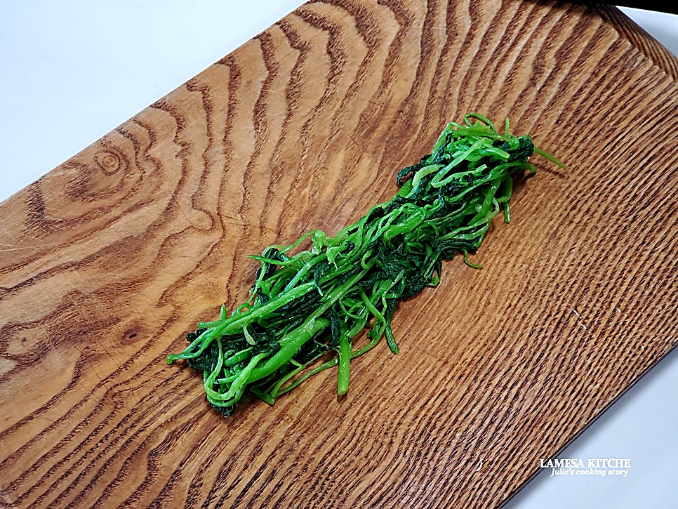 Finely chopping blanched greens